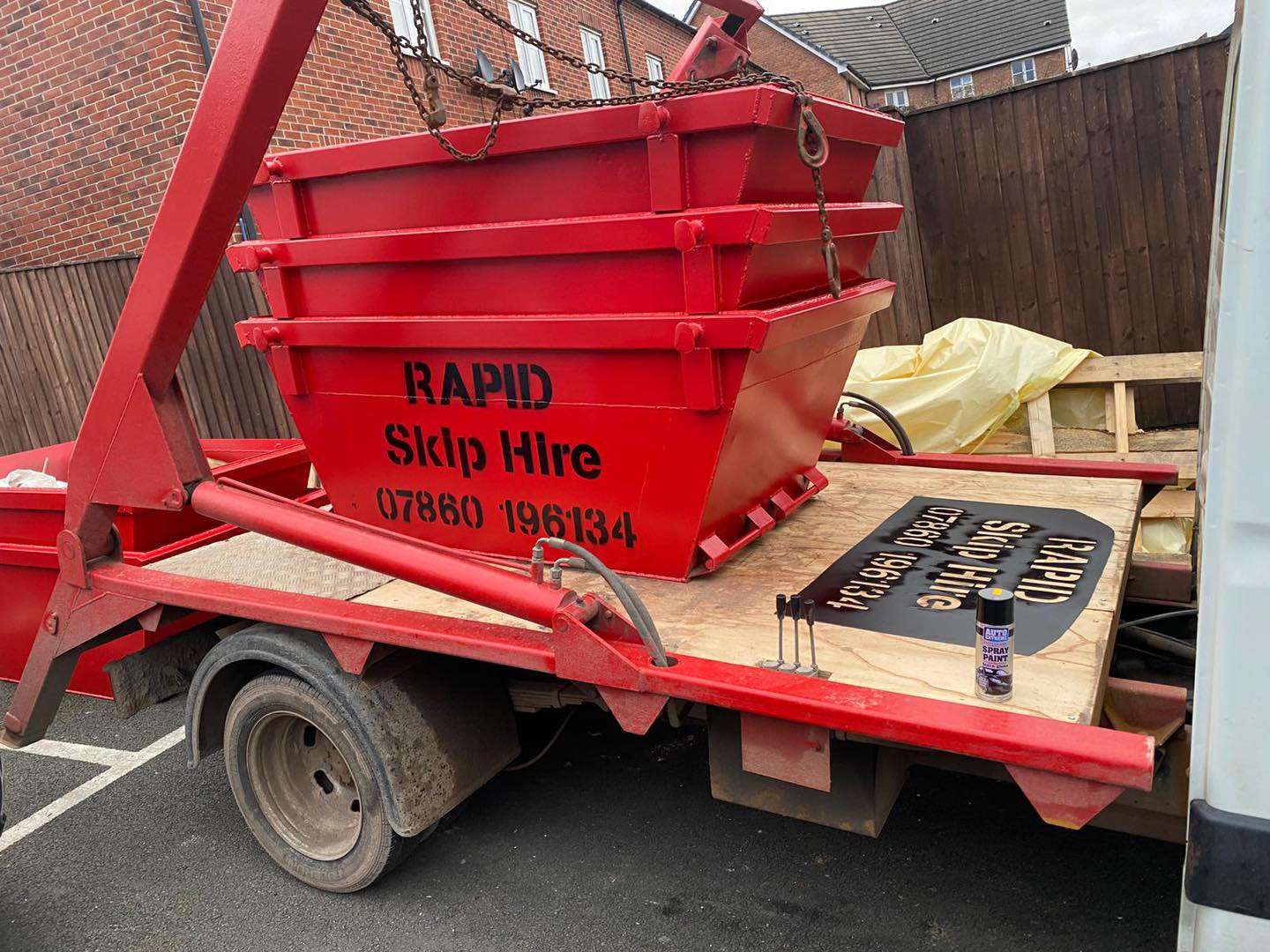 3 red skips stacked on top of eachother reading RAPID skip hire